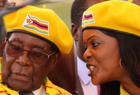President Robert Mugabe listens to his wife Grace Mugabe at a rally of his ruling ZANU(PF) party in Harare, Zimbabwe, November 8, 2017. PHOTO BY REUTERS/Philimon Bulawayo