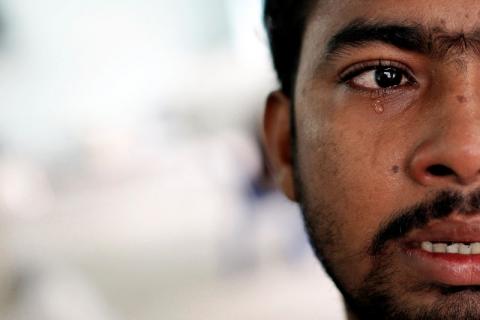 Muhammed Ariful Islam, 22, a Dhaka painter who was held captive on a ship before being abandoned on a remote island, cries at a government shelter in Takua Pa district of Phang Nga, October 17, 2014. PHOTO BY REUTERS/Athit Perawongmetha