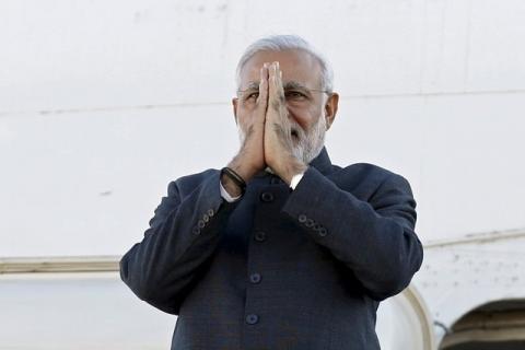 India's Prime Minister Narendra Modi gestures while disembarking from his plane after arriving at Ottawa International Airport, Canada, April 14, 2015. PHOTO BY REUTERS/Chris Wattie