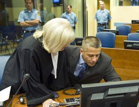 Bosnian Muslim Naser Oric (R) and his lawyer Vasvija Vidovic sit in the courtroom of the International Criminal Tribunal for the former Yugoslavia (ICTY) as he waits for the judgement on his appeal against his war crimes conviction in The Hague, July 3, 2008. PHOTO BY REUTERS/Zoran Lesic