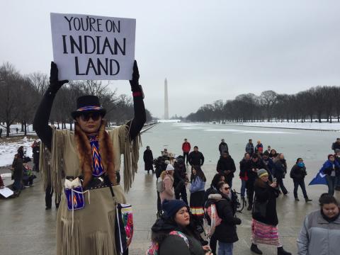 A participant holds a placard during the Indigenous Peoples March at the Lincoln Memorial in Washington, D.C., on Jan. 18, 2019. PHOTO BY Thomson Reuters Foundation/Carey L. Biron