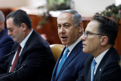 Israeli Prime Minister Benjamin Netanyahu (C) sits next to Cabinet Secretary Tzachi Braverman (R) and Israeli Intelligence and Transportation Minister Israel Katz (L) at the start of the weekly cabinet meeting at the Prime Minister's office in Jerusalem, February 11, 2018. PHOTO BY REUTERS/Ronen Zvulun