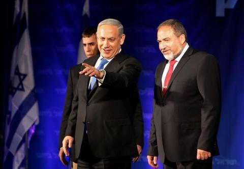 Israel's Prime Minister Benjamin Netanyahu (C) and former foreign minister and head of the Yisrael Beitenu party Avigdor Lieberman (R) look at supporters at the Likud-Yisrael Beitenu headquarters in Tel Aviv, January 23, 2013. PHOTO BY REUTERS/Nir Elias