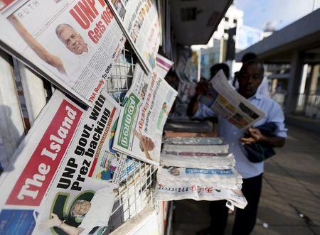 Sri Lankan newspapers with pictures of Prime Minister Ranil Wickremesinghe on their front pages are displayed for sale at a newsstand in Colombo, August 19, 2015. PHOTO BY REUTERS/Dinuka Liyanawatte