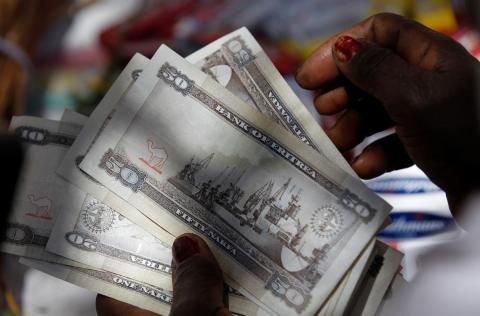 A vendor counts Eritrean "Nakfa" bank notes in downtown Asmara, Eritrea in this photo taken on February 21, 2016. PHOTO BY REUTERS/Thomas Mukoya