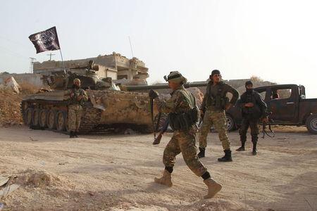 Members of al Qaeda's Nusra Front carry their weapons as they move towards their positions during an offensive to take control of the northwestern city of Ariha from forces loyal to Syria's President Bashar al-Assad, in Idlib province, May 28, 2015. PHOTO BY REUTERS/Ammar Abdullah