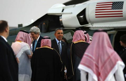 U.S. Secretary of State John Kerry (L) and U.S. President Barack Obama are greeted upon their arrival on Marine One for a meeting with Saudi King Abdullah at Rawdat al-Khraim (Desert Camp) near Riyadh in Saudi Arabia