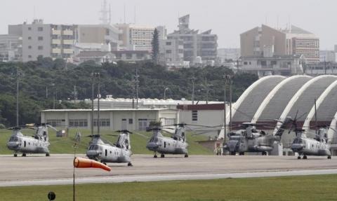 Four Sea Knight transport helicopters and a Super Stallion helicopter are parked at Marine Corps Air Station Futenma in Ginowan on Okinawa, May 3, 2010. PHOTO BY REUTERS/Toru Hanai