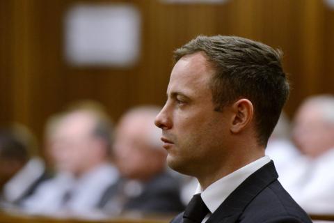 South African Olympic and Paralympic track star Oscar Pistorius attends his sentencing at the North Gauteng High Court in Pretoria, October 21, 2014. PHOTO BY REUTERS/Herman Verwey
