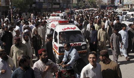 People escort ambulances, carrying victims of an attack on buses, to the hospital in Quetta, Pakistan, May 30, 2015. PHOTO BY REUTERS/Naseer Ahmed