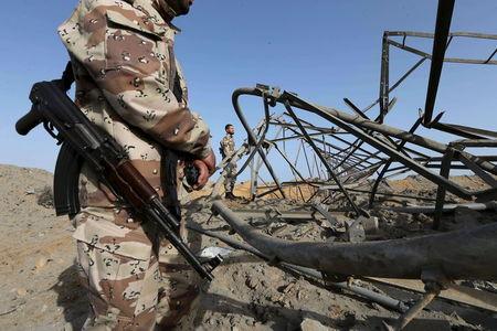 Members of Palestinian security forces loyal to Hamas survey a Hamas site after it was hit by an Israeli airstrike in Rafah in the southern Gaza Strip, May 27, 2015. PHOTO BY REUTERS/Ibraheem Abu Mustafa