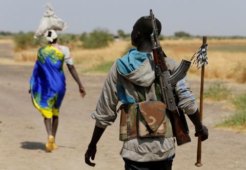An armed man walks on a path close to the village of Nialdhiu, South Sudan, February 7, 2017. PHOTO BY REUTERS/Siegfried Modola