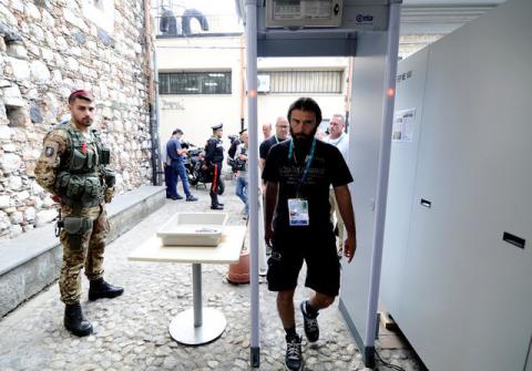 An Italian Army soldier patrols as a man walks through a metal detector in Taormina where leaders from the world's major Western powers will hold their annual summit, Italy, May 24, 2017. PHOTO BY REUTERS/Guglielmo Mangiapane