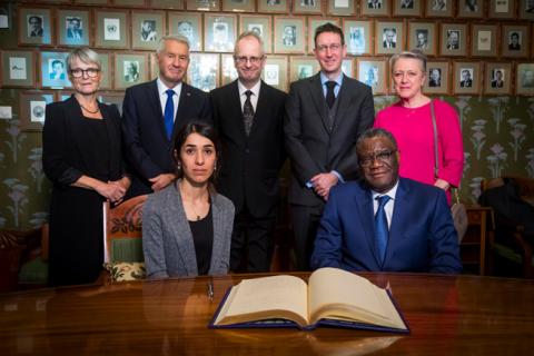 Nadia Murad and Denis Mukwege together with the Norwegian Nobel Peace Prize committee, Anne Enger, Thorbjorn Jagland, Henrik Syse, Asle Toje and Berit Reiss-Andersen, pose for a photograph after a news conference with the 2018 Nobel Laureates at the Nobel Institute in Olso, Norway, December 9, 2018. PHOTO BY REUTERS/Heiko Junge/NTB Scanpix
