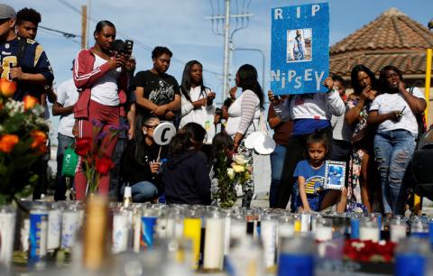 People gather around a makeshift memorial for Grammy-nominated rapper Nipsey Hussle who was shot and killed outside his clothing store in Los Angeles, California, U.S., April 1, 2019. PHOTO BY REUTERS/Mario Anzuoni