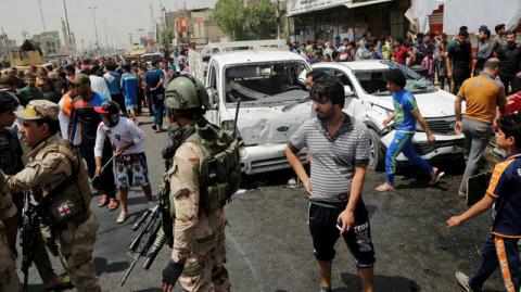 People gather at the scene of a car bomb attack in Baghdad's mainly Shi'ite district of Sadr City, Iraq, May 11, 2016. PHOTO BY REUTERS/Wissm al-Okili