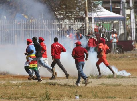 People flee teargas as opposition party supporters clash with police in Harare, Zimbabwe, August 26,2016. PHOTO BY REUTERS/Philimon Bulawayo
