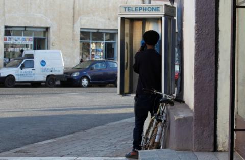 A man uses a public telephone booth along a street in Asmara, Eritrea February 20, 2016. PHOTO BY REUTERS/Thomas Mukoya