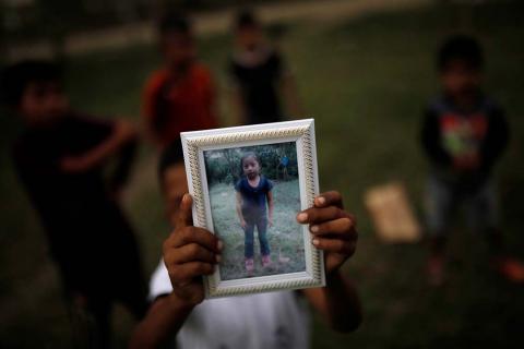 Abdel Caal, brother of Jakelin Caal, holds a picture of his sister outside their home in San Antonio Secortez village in Guatemala, December 22, 2018. PHOTO BY REUTERS/Carlos Barria