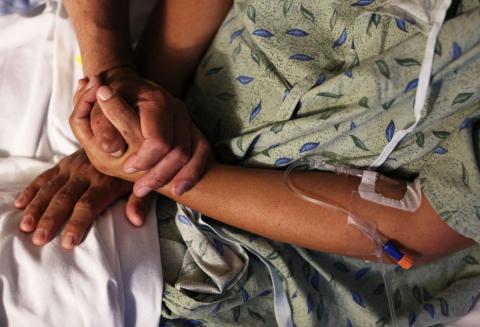 A patient is comforted by her husband at St. Joseph's Hospital in Tucson, Arizona, U.S. September 13, 2017. They were enrolled in health insurance thanks to Maria Losoya, a University of Arizona Center for Rural Health Navigator. PHOTO BY REUTERS/Caitlin O'Hara