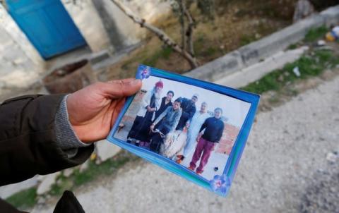 Brother of the Berlin Christmas market truck attack suspect Anis Amri, shows a picture of Anis Amri (C), in Oueslatia, Tunisia December 23, 2016. PHOTO BY REUTERS/Zoubeir Souissi