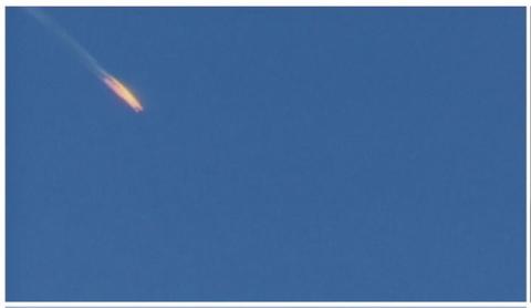 A war plane crashing in flames in a mountainous area in northern Syria after it was shot down by Turkish fighter jets near the Turkish-Syrian border, is seen in this still image taken from video, November 24, 2015. PHOTO BY REUTERS/Reuters TV
