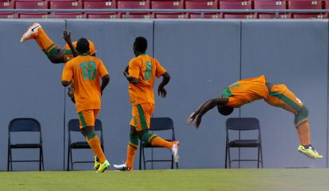 Zambia's Christopher Katongo (behind 18) celebrates with his teammates after he scores against Japan during their international friendly soccer match, ahead of the 2014 World Cup, in Tampa, Florida, June 6, 2014. PHOTO BY REUTERS/Scott Audette