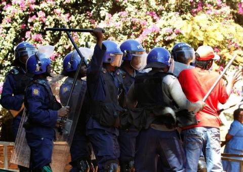 Police officers clash with demonstrators during a protest by opposition party supporters in Harare, Zimbabwe, August 26,2016. PHOTO BY REUTERS/Philimon Bulawayo