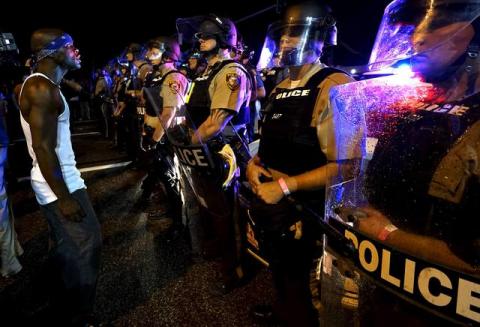 A protester yells at a police line shortly before shots were fired in a police-officer involved shooting in Ferguson, Missouri, August 9, 2015. PHOTO BY REUTERS/Rick Wilking