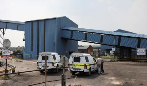Police vehicles are seen by an unused mine where people have been killed by a gas explosion in South Africa's eastern province of Mpumalanga, South Africa, February 7, 2019. PHOTO BY REUTERS/Siphiwe Sibeko