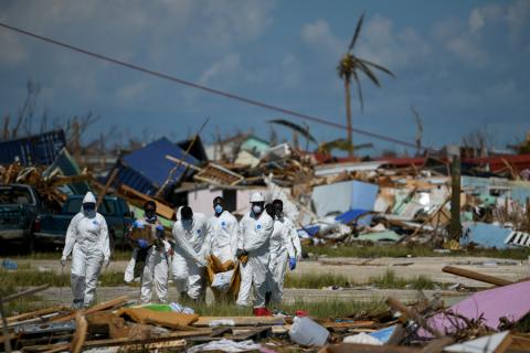 Personnel from the Royal Bahamas Police Force remove a body recovered in a destroyed neighborhood in the wake of Hurricane Dorian in Marsh Harbour, Great Abaco, Bahamas, September 9, 2019. PHOTO BY REUTERS/Loren Elliott