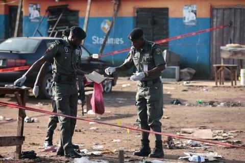 Police bomb squad personnel gather debris for analysis at the scene of a bomb blast in a file photo. PHOTO BY REUTERS/Afolabi Sotunde