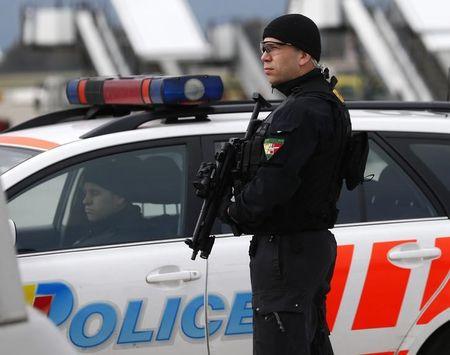 A Geneva police staff holds his position, November 23, 2013. PHOTO BY REUTERS/Denis Balibouse