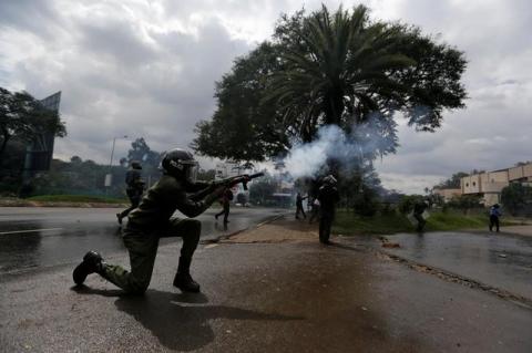 A riot policeman lobs a teargas canister to disperse supporters of the opposition Coalition for Reforms and Democracy (CORD), during a protest at the premises hosting the headquarters of Independent Electoral and Boundaries Commission (IEBC) to demand the disbandment of the electoral body ahead of next year's election in Nairobi, Kenya, May 9, 2016. PHOTO BY REUTERS/Thomas Mukoya