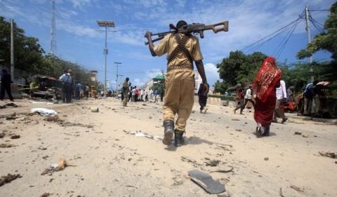 A Somali policeman walks towards the scene of an explosion outside the headquarters of Somalia's Criminal Investigation Department (CID) in the capital Mogadishu, July 31, 2016. PHOTO BY REUTERS/Ismail Taxta