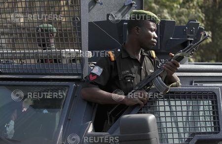 A police officer keeps watch during a protest against the elimination of a popular fuel subsidy that has doubled the price of petrol, in Nigeria's capital Abuja, January 9, 2012. PHOTO BY REUTERS/Afolabi Sotunde