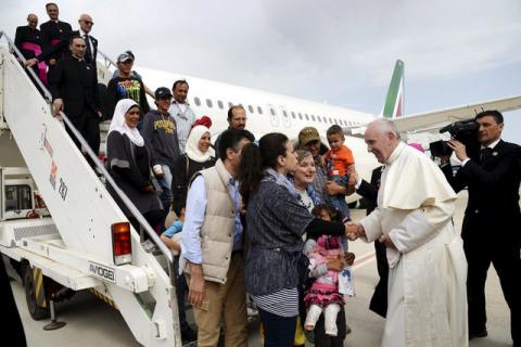 Pope Francis welcomes a group of Syrian refugees after landing at Ciampino airport in Rome following a visit at the Moria refugee camp in the Greek island of Lesbos, April 16, 2016. PHOTO BY REUTERS/Filippo Monteforte