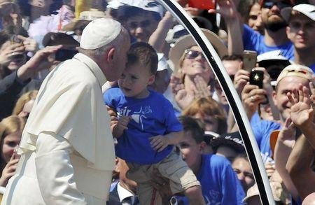 Pope Francis kisses a child as he leaves the stadium in his Papamobile after celebrating a Holy Mass in Sarajavo, Bosnia and Herzegovina, June 6, 2015. REUTERS/Dado Ruvic