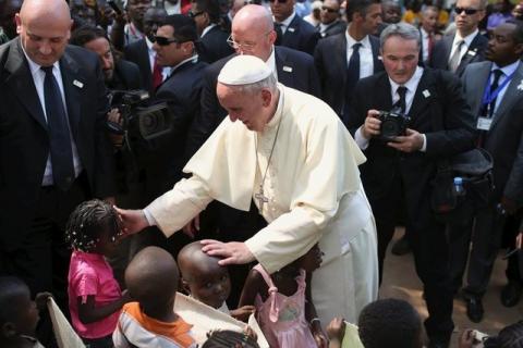 Pope Francis greets internally displaced children sheltered on the grounds of the Saint Sauveur church, during his visit in the capital Bangui, Central African Republic, November 29, 2015. PHOTO BY REUTERS/Siegfried Modola