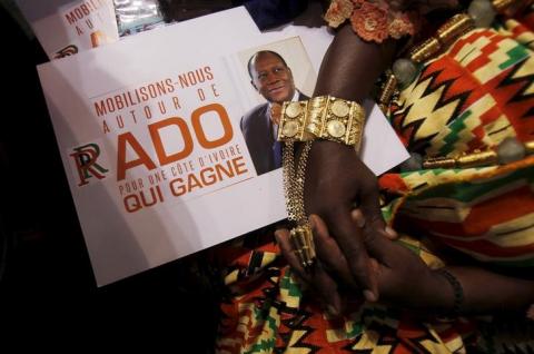 A tribal chief holds a poster, which has a portrait of incumbent president Alassane Ouattara on it, during the congress of the Rally of the Republicans (RDR) at the Treichville sports complex in downtown Abidjan, March 22, 2015. PHOTO BY REUTERS/Luc Gnago