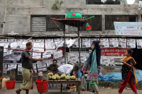 Posters and a replica of a boat, the voting symbol of Bangladesh Awami League, are seen as people walk on a street in Dhaka, Bangladesh, December 25, 2018. PHOTO BY REUTERS/Mohammad Ponir Hossain