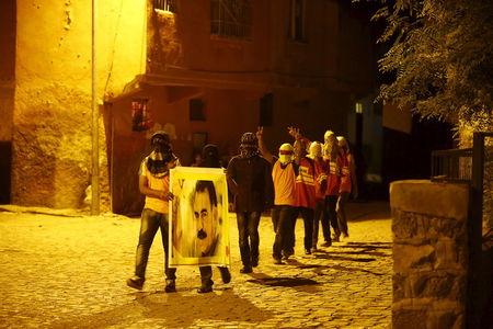Masked members of YDG-H, youth wing of the outlawed Kurdistan Workers Party (PKK), shout slogans as they hold a portrait of Kurdistan Workers Party (PKK)'s jailed leader Abdullah Ocalan in Diyarbakir, Turkey, September 1, 2015. PHOTO BY REUTERS/Osman Orsal