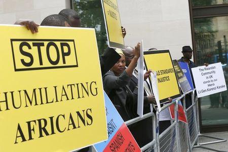 Protesters hold placards demanding the release of Rwanda's intelligence chief Karenzi Karake outside Westminster Magistrates Court in London, Britain, June 25, 2015. PHOTO BY REUTERS/Stefan Wermuth