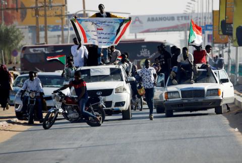 Sudanese people gather on a street and wave flags during the first anniversary of the start of the uprising that toppled long-time ruler Omar al-Bashir, in Khartoum, Sudan, December 19, 2019. PHOTO BY REUTERS/Mohamed Nureldin Abdallah