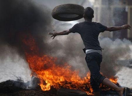 A protester sets up a barricade during a protest against Burundi President Pierre Nkurunziza and his bid for a third term in Bujumbura, Burundi, May 26, 2015. PHOTO BY REUTERS/Goran Tomasevic