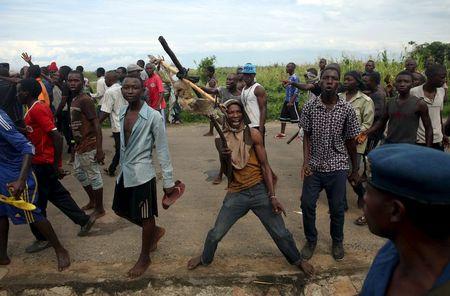A protestor holds up a dead owl attached to a stick, intended to denigrate the ruling party whose emblem is an eagle, during a protest in Buterere neighbourhood of Bujumbura, Burundi, May 12, 2015. PHOTO BY REUTERS/Goran Tomasevic