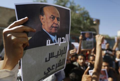 A protester holds up a poster of Abd-Rabbu Mansour Hadi during an anti-Houthi demonstration in Sanaa, February 21, 2015. PHOTO BY REUTERS/Khaled Abdullah