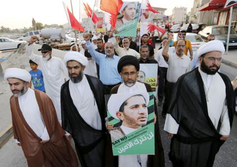 Protesters hold photos of Sheikh Ali Salman, Bahrain's main opposition leader and Secretary-General of Al-Wefaq Islamic Society, as they march asking for his release in the village of Jidhafs, west of Manama, Bahrain, June 16, 2015. PHOTO BY REUTERS/Hamad I Mohammed