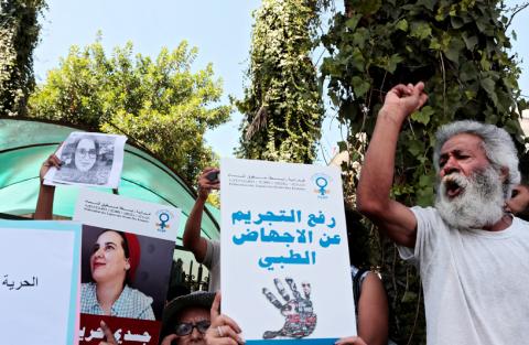 Moroccan activists hold banners during a protest in solidarity with Hajar Raissouni, a journalist charged with fornication and abortion, outside the Rabat tribunal, Morocco, September 9, 2019. PHOTO BY REUTERS/Youssef Boudlal