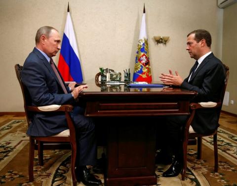 Russian President Vladimir Putin (L) listens to Prime Minister Dmitry Medvedev during their meeting in Crimea, August 19, 2016. PHOTO BY REUTERS/Dmitry Astakhov